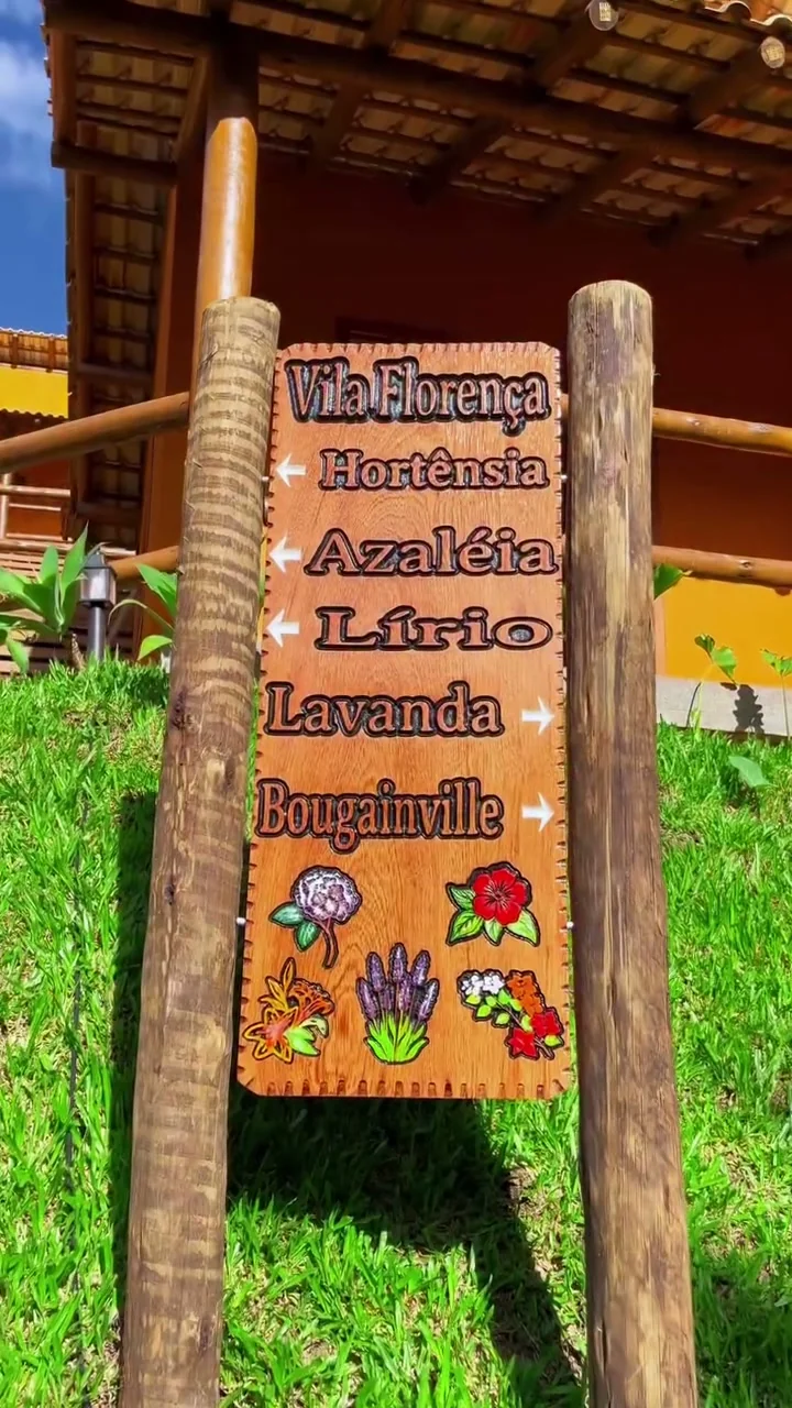 Placa de sinalização do Vila Florença com os nomes dos chalés: Hortênsia, Azaléia, Lírio, Lavanda, Bougainville